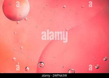 Abstract pink colorful background with oil on water surface. Oil drops in water abstract psychedelic, abstract image. Stock Photo