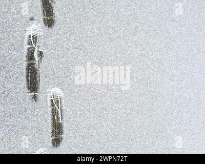 The imprint of the shoe sole with profile in the soft snow leaves traces and patterns Stock Photo