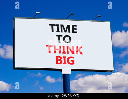 Time to think big symbol. Concept words Time to think big on beautiful big white billboard. Beautiful blue sky cloud background. Business and time to Stock Photo