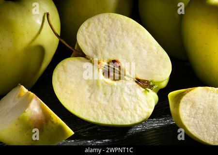 sliced apple on black wood background Stock Photo