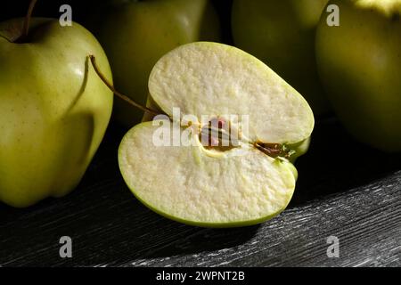 sliced apple on black wood background Stock Photo