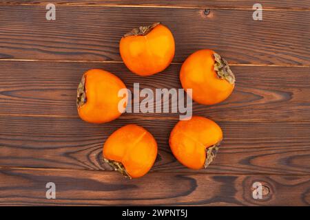 persimmon on wood background top view Stock Photo