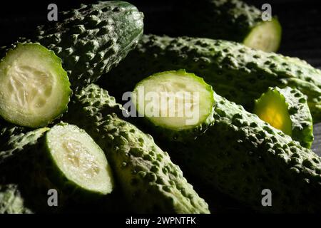 sliced fresh pickling cucumber heap on black background Stock Photo