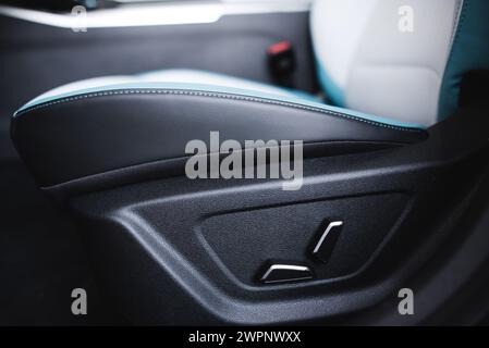 Luxury car seats. Adjustment buttons for the electric seat. Close up view of modern car leather seat at the luxury interior. High quality photo Stock Photo