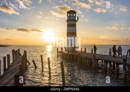 Podersdorf am See, sunset at lighthouse at Lake Neusiedl, people in Neusiedler See (Lake Neusiedl), Burgenland, Austria Stock Photo