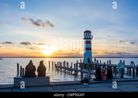 Podersdorf am See, sunset at lighthouse at Lake Neusiedl, people in Neusiedler See (Lake Neusiedl), Burgenland, Austria Stock Photo
