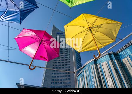 Colorful umbrellas and the MDR high-rise building MDR-Kubus on Augustusplatz, Leipzig, Saxony, Germany Stock Photo