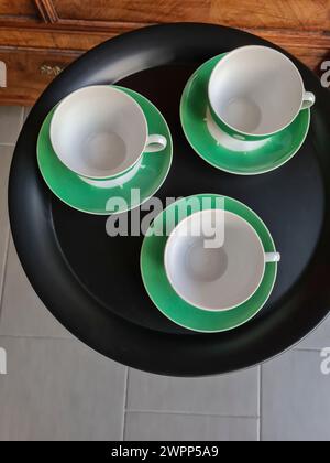 View from above of three empty coffee cups on a black round table Stock Photo