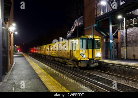 Merseyrail electrics class 508 third rail electric train 508104 at St Michaels railway station, Liverpool, UK at night Stock Photo