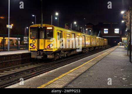 Merseyrail electrics class 508 third rail electric train 508104 at Formby railway station, Liverpool, UK at night Stock Photo