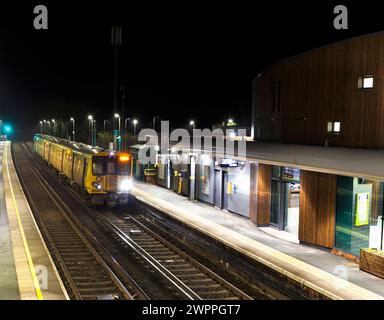 Merseyrail electrics class 507 third rail electric train 507017 at Ainsdale railway station, Southport, UK at night Stock Photo