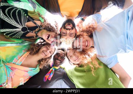 A group of people are standing in a circle with their heads together Stock Photo