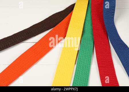 Colorful karate belts on wooden background, closeup Stock Photo