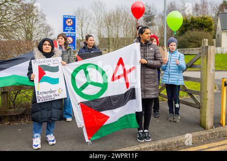 Bingley, UK. 08 MAR, 2024. Pro Palestine demonstrators stand outside Cottingley Primary. Story: Parents of students at Cottingley Village Primary School pulled their children out at 2PM on the 8th of march as part of a co-ordinated strike effort across multiple different schools across Yorkshire for Palestine. Credit Milo Chandler/Alamy Live News Stock Photo