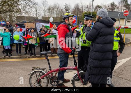 Bingley, UK. 08 MAR, 2024. A hostile parent talks to a pro palestinian demonstrator as the police prepare to intervene. Story: Parents of students at Cottingley Village Primary School pulled their children out at 2PM on the 8th of march as part of a co-ordinated strike effort across multiple different schools across Yorkshire for Palestine. Credit Milo Chandler/Alamy Live News Stock Photo