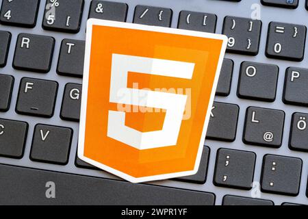 Orange HTML5 markup language logo sticker desktop PC computer keyboard, web development technology work concept, learning languages, using HTML 5 simp Stock Photo