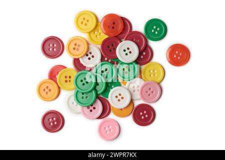 pile of colorful buttons isolated on white background, glossy and vibrant colored plastic sewing accessories for garments and craft projects Stock Photo