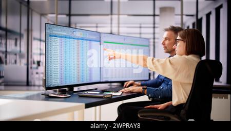 Analyst Employee Working On Spreadsheet Using Desktop Computer Stock Photo