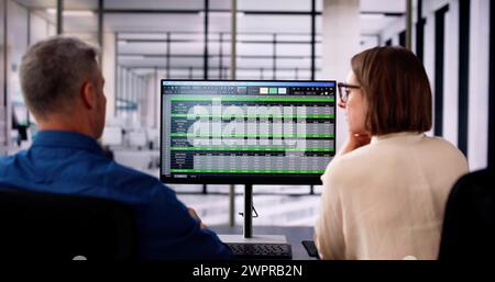Analyst Employee Working On Spreadsheet Using Desktop Computer Stock Photo