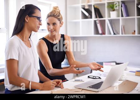 Fashion designer, woman and teamwork on laptop for planning, brainstorming and talking of creative project. Tailor or business people on computer for Stock Photo