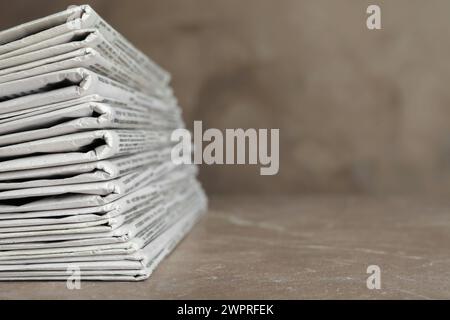 Stack of newspapers on marble table, closeup. Journalist's work Stock Photo