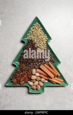 Different spices and nuts on light gray textured table, top view Stock Photo