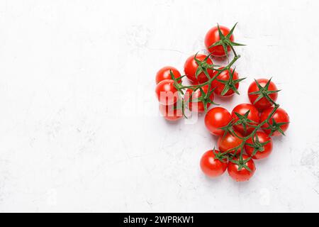 Cherry tomatoes on branches with copy space on white background, top view Stock Photo
