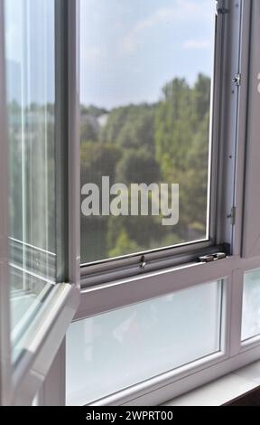 plastic balcony window. street view from the window. vertical Stock Photo