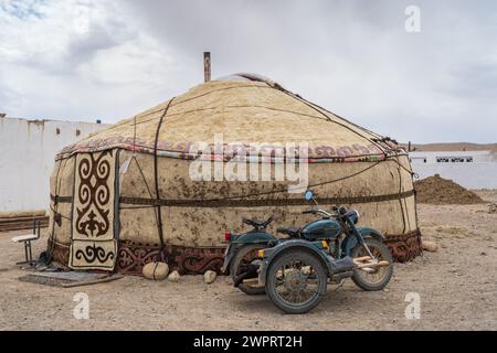 View of traditional kyrgyz felt yurt and vintage soviet era motorcycle in high-altitude Alichur village on Pamir Highway, Gorno-Badakshan, Tajikistan Stock Photo