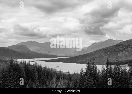 Overlooking Loch Loyne, this grayscale landscape showcases the rugged beauty of the Scottish Highlands, with layered mountain ranges under a textured Stock Photo