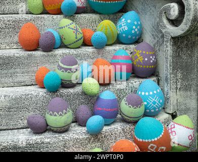 Decorative Easter eggs with a pattern on the stairs, selective focus. Multicolored Paschal eggs rows. Stock Photo