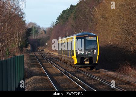 Merseyrail Stadler class 777 3rd rail electric train 777023 arriving at Bache, Cheshire, UK. Stock Photo