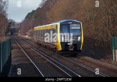 Merseyrail Stadler class 777 3rd rail electric train 777002 arriving at Bache, Cheshire, UK. Stock Photo