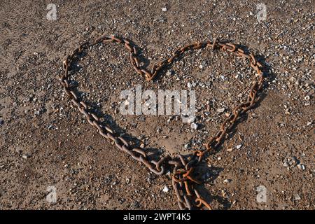 heart shaped metal chain on beach Stock Photo