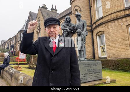 Barnsley, UK. 09 MAR, 2024. Arthur Scargill, British trade unionist and Miners strike leader,  stands statue memorial to fallen miners outside the National Union of Mineworkers hall in Barnsley. This is ahead of the 40th Aniversary of the Miners strikes. Credit Milo Chandler/Alamy Live News Stock Photo
