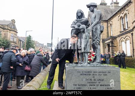 Barnsley, UK. 09 MAR, 2024. Members lay wreathes at the memorial to fallen mineworkers statue, outside the Barnsley National Union of Mineworkers hall in Barnsley, comomorating those who lost their lives during the miners strikes 40 years since the strikes.  Credit Milo Chandler/Alamy Live News Stock Photo