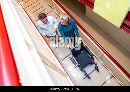 Top view of a man with down syndrome and caregiver using wheelchair Stock Photo