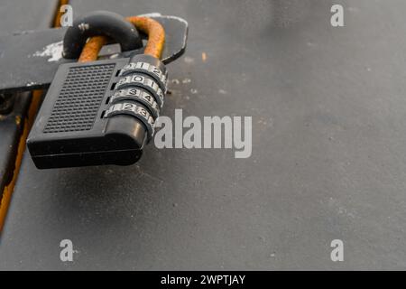 Closeup of rusty metal combination lock fastened to latch in South Korea Stock Photo