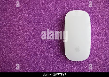 KYIV, UKRAINE - NOVEMBER 27, 2023 Apple Magic Mouse 3rd generation lies on sparkling glitter surface close up Stock Photo