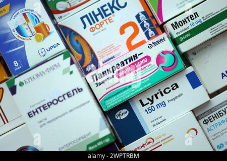 KYIV, UKRAINE - NOVEMBER 27, 2023 Many boxes of pills and capsules stacked in pharmacy drug store close up Stock Photo