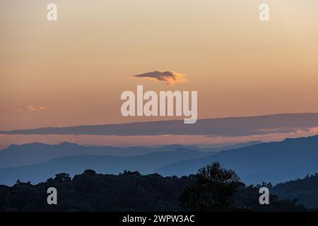 A very little cloud floats at the horizon, in a beautiful dusk over the eastern Andean mountains of central Colombia. Stock Photo