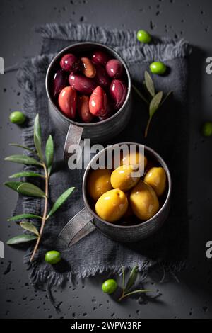 Green and ripe olives with mortar and twig. Freshly picked green olives. Stock Photo