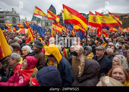 Madrid, Spain. 09th Mar, 2024. Protesters hold Spanish flags during a rally organized by the Freedom and Alternative Forum under the motto 'There are plenty of reasons: Sánchez resigns.' Hundreds of people with Spanish flags gathered in the Plaza de Cibeles in the Center of Madrid, to protest against the plans of the Spanish Government led by Pedro Sanches, to give amnesty to those linked to the referemdum in Catalonia in 2017. Credit: SOPA Images Limited/Alamy Live News Stock Photo