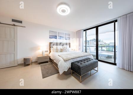 an image of a luxury bedroom with private balcony in the heart of the town of Marbella Stock Photo