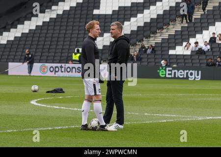 Salford City's manager Karl Robinson chats with Milton Keynes Dons Dean Lewington before the Sky Bet League 2 match between MK Dons and Salford City at Stadium MK, Milton Keynes on Friday 8th March 2024. (Photo: John Cripps | MI News) Credit: MI News & Sport /Alamy Live News Stock Photo