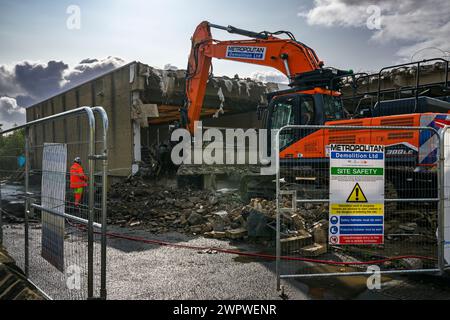 Demolition site (rubble, heavy machinery, building deconstruction, controlled collapse, empty shell) - Baildon library, West Yorkshire, England, UK. Stock Photo