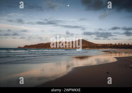 Byron Bay lighthouse high on the rocky headland - the most eastern point of Australian continent facing Pacific ocean in elevated aerial seascape Stock Photo