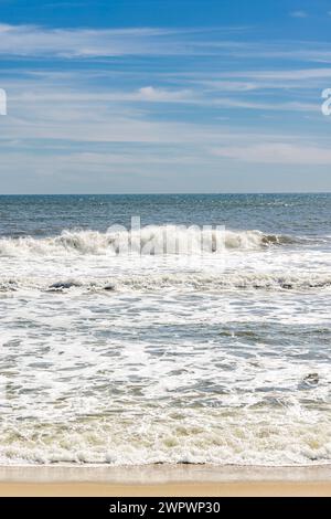 verticla image of waves coming in on an ocean beach in the hamptons Stock Photo