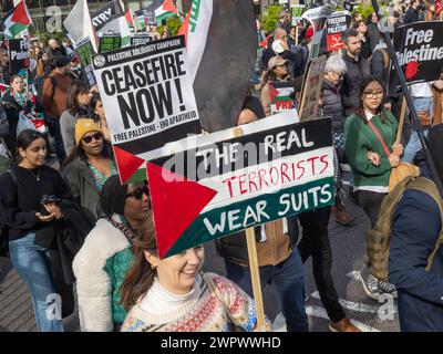 London, UK. 9 Mar 2024. 'The Real Terrorists Wear Suits.' A huge peaceful march to the US Embassy demands a full ceasefire in Gaza and an end to Israeli genocide. The IDF has now killed over 30,000 people, mainly women and children, continue to ignore the ICJ ruling to avoid genocide and preparing a brutal assault on Rafah. Israel continues to stop the humanitarian aid and medical supplies needed to avoid mass deaths from disease and starvation and spread lies about UNRWA whose funding is essential. Peter Marshall/Alamy Live News Stock Photo