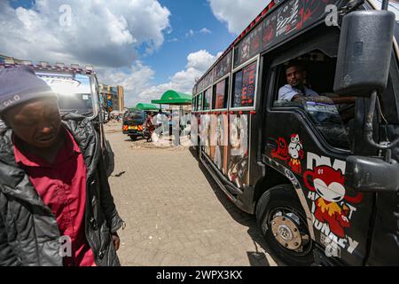 Nairobi, Nairobi, Kenya. 9th Mar, 2024. A man looks out the window while driving through a matatu hub in Ngong Hills in Nairobi.Matatu, or mathree in sheng, is a typical form of transportation, derived from the 60s and increasingly popularized in the day to day fair of over 70% Kenyans in Nairobi. They are elaborately decorated and are deeply part of Kenyan culture, unlike other parts of East Africa. (Credit Image: © Bianca Otero/ZUMA Press Wire) EDITORIAL USAGE ONLY! Not for Commercial USAGE! Stock Photo